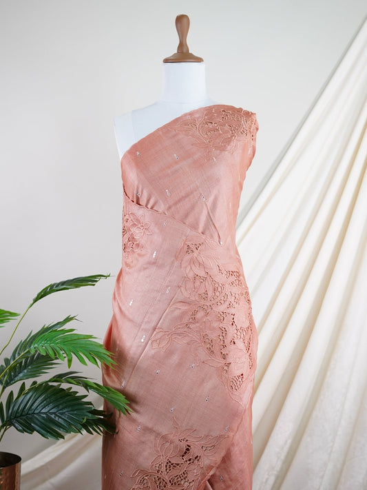 Tussars An orangish-peach Tussar saree that is extremely soft and flowing, featuring cutwork on the borders, pallu, and blouse, accented with lightweight mirror details for subtle sparkle. Kalyani - Manoranjitham Weaves - Handloom Store