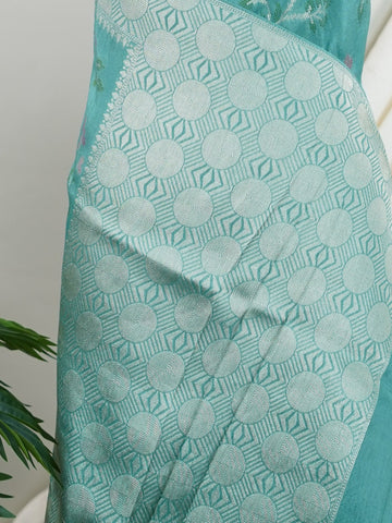 Georgette This Tussar Georgette saree from Varanasi brings together the textured richness of tussar silk with the fluid grace of georgette. Woven on a powerloom, it drapes light and airy, perfect for effortless elegance. Ideal for both day events and evening gatherings, it reflects quiet sophistication with a modern twist on tradition. Kamakshi - Georgette Saree | Handwoven | Varanasi - Manoranjitham Weaves - Handloom Store