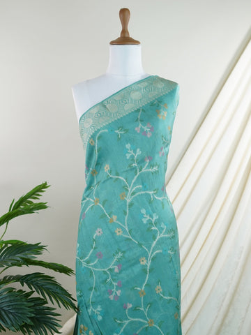 Georgette This Tussar Georgette saree from Varanasi brings together the textured richness of tussar silk with the fluid grace of georgette. Woven on a powerloom, it drapes light and airy, perfect for effortless elegance. Ideal for both day events and evening gatherings, it reflects quiet sophistication with a modern twist on tradition. Kamakshi - Georgette Saree | Handwoven | Varanasi - Manoranjitham Weaves - Handloom Store