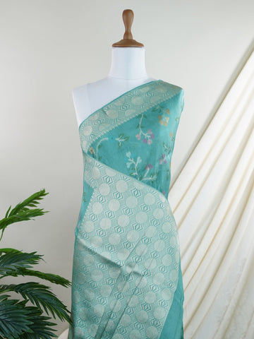 Georgette This Tussar Georgette saree from Varanasi brings together the textured richness of tussar silk with the fluid grace of georgette. Woven on a powerloom, it drapes light and airy, perfect for effortless elegance. Ideal for both day events and evening gatherings, it reflects quiet sophistication with a modern twist on tradition. Kamakshi - Georgette Saree | Handwoven | Varanasi - Manoranjitham Weaves - Handloom Store