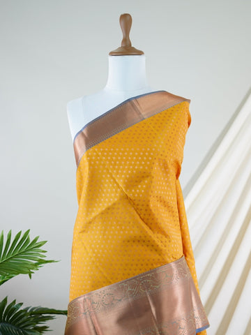 Kanchipuram Silk A masterpiece from Kanchipuram, this Kanjivaram saree in Yellow is a tribute to India's rich handloom legacy. The Pure Zari weaving and Buttis motifs make it a perfect choice for brides and celebrations. Every thread speaks of elegance, tradition, and the skilled hands that bring this saree to life. Mohanam - Manoranjitham Weaves - Handloom Store