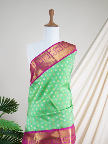 Kanchipuram Silk A masterpiece from Kanchipuram, this Kanjivaram saree in Lime Tree Green is a tribute to India's rich handloom legacy. The Pure Zari weaving and Buttis motifs make it a perfect choice for brides and celebrations. Every thread speaks of elegance, tradition, and the skilled hands that bring this saree to life. Nattakurinji - Manoranjitham Weaves - Handloom Store