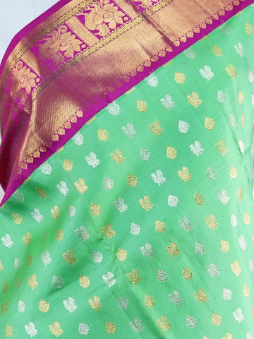 Kanchipuram Silk A masterpiece from Kanchipuram, this Kanjivaram saree in Lime Tree Green is a tribute to India's rich handloom legacy. The Pure Zari weaving and Buttis motifs make it a perfect choice for brides and celebrations. Every thread speaks of elegance, tradition, and the skilled hands that bring this saree to life. Nattakurinji - Manoranjitham Weaves - Handloom Store