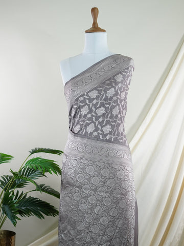 Katan Woven in the heart of Varanasi, this georgette saree features an intricate all-over jaal that glistens across its fluid, lightweight fabric. Elegant and ethereal, it brings together tradition and ease—ideal for evening celebrations and graceful occasions.br
#GeorgetteSaree #JaalWork #VaranasiWeaves #EtherealElegance #HandloomGrace #Manoranjitham #ManoranjithamStyle Nirmala - Georgette Saree | Full Jaal Zari - Manoranjitham Weaves - Handloom Store
