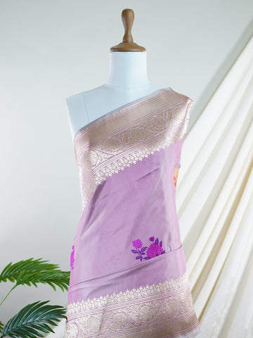 Katan An exquisite creation from Varanasi, this glass tissue saree is adorned with delicate embroidery and refined ari pita work. Its sheer texture catches the light with every fold, while the intricate detailing adds depth and artistry. A luminous drape for occasions steeped in grace and tradition. Padmini - Manoranjitham Weaves - Handloom Store