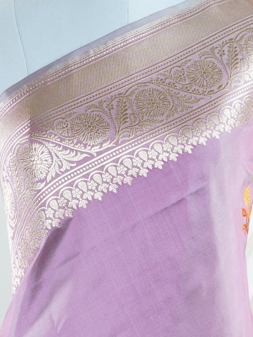 Katan An exquisite creation from Varanasi, this glass tissue saree is adorned with delicate embroidery and refined ari pita work. Its sheer texture catches the light with every fold, while the intricate detailing adds depth and artistry. A luminous drape for occasions steeped in grace and tradition. Padmini - Manoranjitham Weaves - Handloom Store
