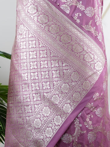 Katan Ponnarajula embodies the golden hues of blooms, a full jaal Katan silk saree that gracefully envelops you in elegance. This exquisite piece showcases a stunning interplay of colors skillfully woven into the fabric, creating a radiant visual impact. Adorned with intricate pure zari detailing and refined handwork, it is ideal for festive occasions and special celebrations. Embrace the rich heritage of Varanasi craftsmanship with Ponnarajula, a timeless symbol of beauty. Ponnarajula - Banarasi Katan Silk