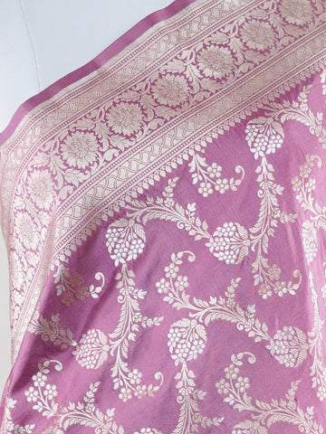 Katan Ponnarajula embodies the golden hues of blooms, a full jaal Katan silk saree that gracefully envelops you in elegance. This exquisite piece showcases a stunning interplay of colors skillfully woven into the fabric, creating a radiant visual impact. Adorned with intricate pure zari detailing and refined handwork, it is ideal for festive occasions and special celebrations. Embrace the rich heritage of Varanasi craftsmanship with Ponnarajula, a timeless symbol of beauty. Ponnarajula - Banarasi Katan Silk