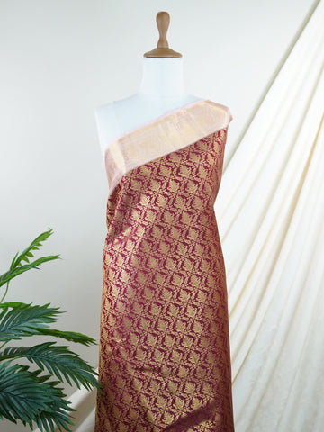 Kanchipuram Silk Beautiful bridal Kanjivaram saree adorned with a rich Butter Burgundy body, elegantly paired with a Pastel Pink border, pallu, and matching blouse. Lavishly woven with all-over gold and silver tissue, adding a regal shimmer and luxurious appeal to the ensemble. The striking blend of deep Burgundy and soft Pastel Pink creates a graceful balance of grandeur and femininity. A timeless bridal drape that celebrates exquisite craftsmanship, making it perfect for weddings and cherished occasions. 