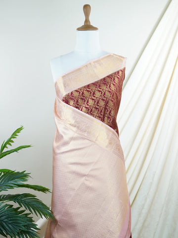 Kanchipuram Silk Beautiful bridal Kanjivaram saree adorned with a rich Butter Burgundy body, elegantly paired with a Pastel Pink border, pallu, and matching blouse. Lavishly woven with all-over gold and silver tissue, adding a regal shimmer and luxurious appeal to the ensemble. The striking blend of deep Burgundy and soft Pastel Pink creates a graceful balance of grandeur and femininity. A timeless bridal drape that celebrates exquisite craftsmanship, making it perfect for weddings and cherished occasions. 