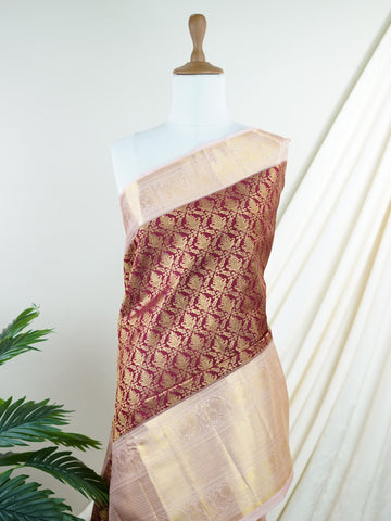 Kanchipuram Silk Beautiful bridal Kanjivaram saree adorned with a rich Butter Burgundy body, elegantly paired with a Pastel Pink border, pallu, and matching blouse. Lavishly woven with all-over gold and silver tissue, adding a regal shimmer and luxurious appeal to the ensemble. The striking blend of deep Burgundy and soft Pastel Pink creates a graceful balance of grandeur and femininity. A timeless bridal drape that celebrates exquisite craftsmanship, making it perfect for weddings and cherished occasions. 