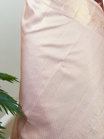 Kanchipuram Silk Beautiful bridal Kanjivaram saree adorned with a rich Butter Burgundy body, elegantly paired with a Pastel Pink border, pallu, and matching blouse. Lavishly woven with all-over gold and silver tissue, adding a regal shimmer and luxurious appeal to the ensemble. The striking blend of deep Burgundy and soft Pastel Pink creates a graceful balance of grandeur and femininity. A timeless bridal drape that celebrates exquisite craftsmanship, making it perfect for weddings and cherished occasions. 