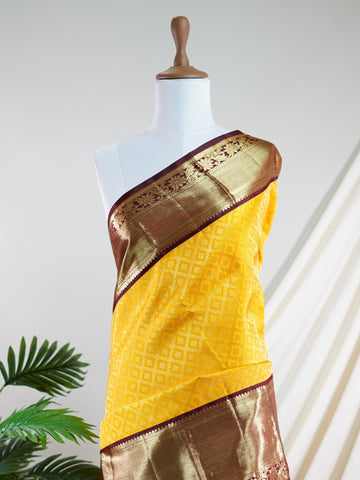 Kanchipuram Silk A masterpiece from Kanchipuram, this Kanjivaram saree in Yellow is a tribute to India's rich handloom legacy. The Pure Zari weaving and Buttis motifs make it a perfect choice for brides and celebrations. Every thread speaks of elegance, tradition, and the skilled hands that bring this saree to life. Priya - Yellow Pure Kanjivaram Silk Saree | Pure Zari - Manoranjitham Weaves - Handloom Store