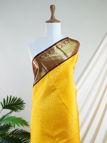 Kanchipuram Silk A masterpiece from Kanchipuram, this Kanjivaram saree in Yellow is a tribute to India's rich handloom legacy. The Pure Zari weaving and Buttis motifs make it a perfect choice for brides and celebrations. Every thread speaks of elegance, tradition, and the skilled hands that bring this saree to life. Priya - Yellow Pure Kanjivaram Silk Saree | Pure Zari - Manoranjitham Weaves - Handloom Store
