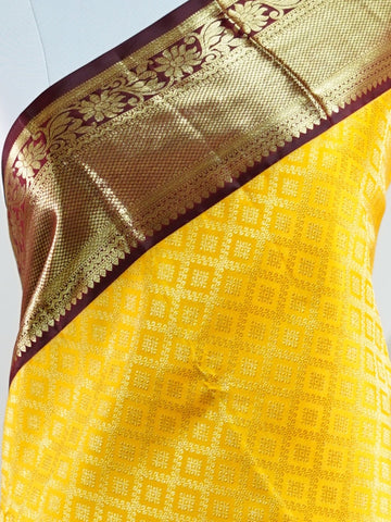 Kanchipuram Silk A masterpiece from Kanchipuram, this Kanjivaram saree in Yellow is a tribute to India's rich handloom legacy. The Pure Zari weaving and Buttis motifs make it a perfect choice for brides and celebrations. Every thread speaks of elegance, tradition, and the skilled hands that bring this saree to life. Priya - Yellow Pure Kanjivaram Silk Saree | Pure Zari - Manoranjitham Weaves - Handloom Store