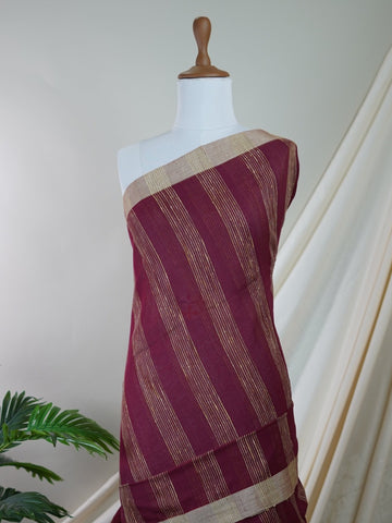 Handspun Cotton A masterpiece from Gujarat, this Handpsun Cotton saree in Maroon is a tribute to India's rich handloom legacy. The nan weaving and Handwork motifs make it a perfect choice for brides and celebrations. Every thread speaks of elegance, tradition, and the skilled hands that bring this saree to life. Rageshree - Maroon Handloom Cotton Saree | Zari Border | Traditional - Manoranjitham Weaves - Handloom Store