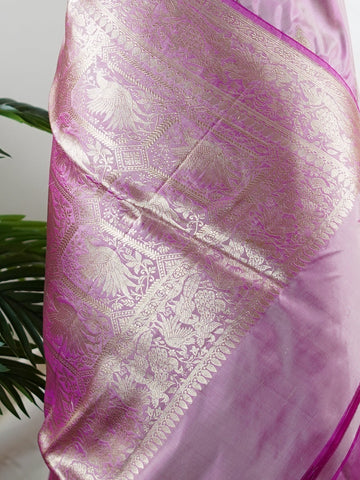 Katan Rathi, named after the vibrant rathi flower, is a full jaal Katan silk saree that showcases a brilliant blend of colors, enhancing your charm. This beautiful piece features intricate patterns woven into the fabric, evoking the essence of blooming flora. Adorned with pure zari detailing and exquisite handwork, it is perfect for celebrations and cultural events. Embrace the tradition of Varanasi weaving with Rathi, a timeless masterpiece of elegance. Rathi  - Manoranjitham Weaves - Handloom Store