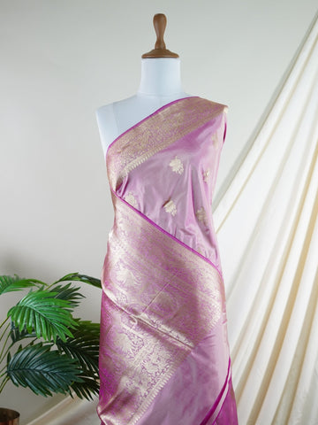 Katan Rathi, named after the vibrant rathi flower, is a full jaal Katan silk saree that showcases a brilliant blend of colors, enhancing your charm. This beautiful piece features intricate patterns woven into the fabric, evoking the essence of blooming flora. Adorned with pure zari detailing and exquisite handwork, it is perfect for celebrations and cultural events. Embrace the tradition of Varanasi weaving with Rathi, a timeless masterpiece of elegance. Rathi  - Manoranjitham Weaves - Handloom Store