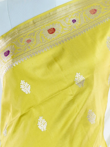 Katan An exquisite creation from Varanasi, this glass tissue saree is adorned with delicate embroidery and refined ari pita work. Its sheer texture catches the light with every fold, while the intricate detailing adds depth and artistry. A luminous drape for occasions steeped in grace and tradition. Sharadamba - Manoranjitham Weaves - Handloom Store