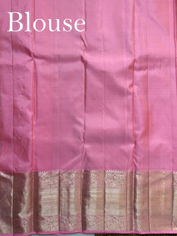 Kanchipuram Silk This Kanjivaram silk saree, adorned in Light Pink and detailed with Pure Zari weaving, reflects the grandeur of Kanchipuram. The timeless Buttis motifs enhance its bridal charm. A perfect blend of luxury and tradition, it is designed for those who appreciate fine craftsmanship. Sindhu - Manoranjitham Weaves - Handloom Store