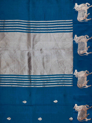 Katan A masterpiece from Varanasi, this Banarasi Katan saree in Dark Teal is a tribute to India's rich handloom legacy. The Tested Zari weaving and Motifs motifs make it a perfect choice for brides and celebrations. Every thread speaks of elegance, tradition, and the skilled hands that bring this saree to life. Sohinia - Banarasi Katan Silk Saree | Woven Motifs - Manoranjitham Weaves - Handloom Store