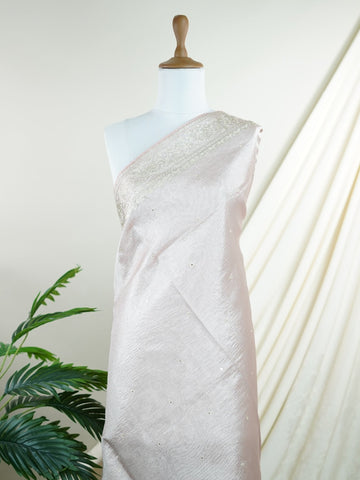 Tissue This semi-crush tissue saree from Varanasi radiates subtle elegance with its fine zari detailing and delicate embroidery. The fluid drape and medium weight lend it a graceful fall, ideal for refined gatherings and celebrations. A powerloom weave crafted with care, it offers timeless appeal in every pleat. Yamana - Semi Silk Saree - Manoranjitham Weaves - Handloom Store